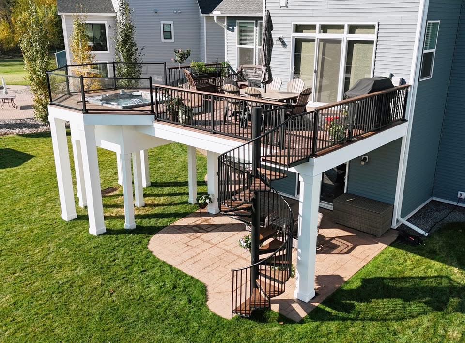 Elevated composite deck with spiral staircase and hot tub built by Dream Decks in Minnesota