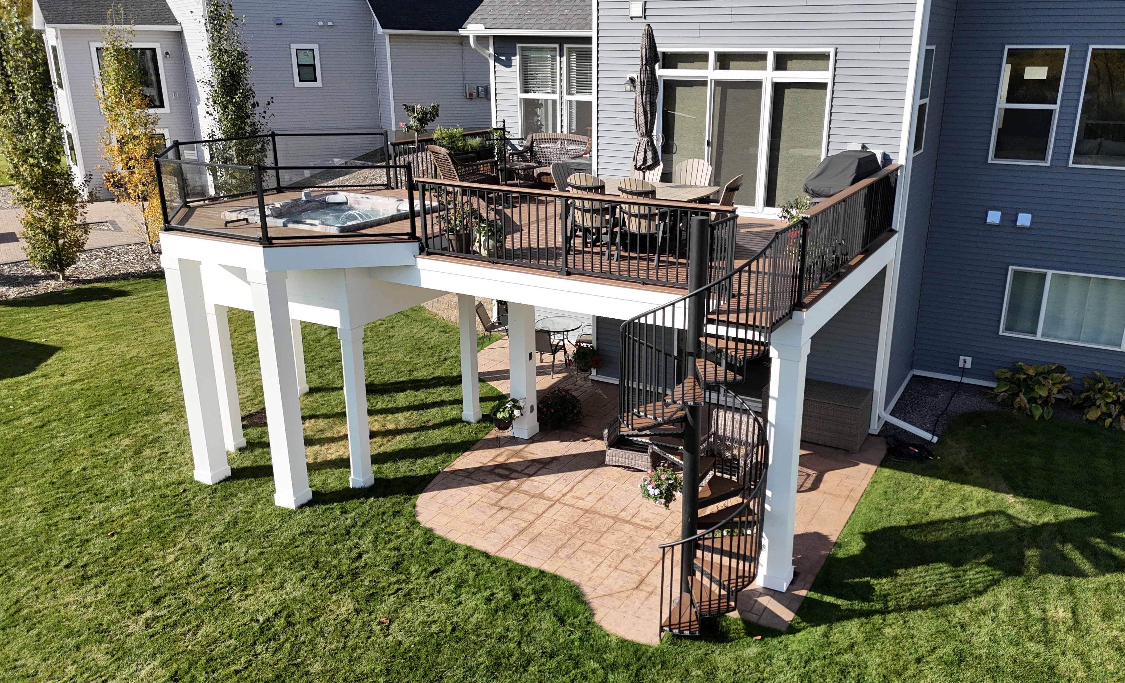 Elevated Deck with Spiral Staircase & Hot Tub - Custom deck built by Dream Decks in Twin Cities, Minnesota